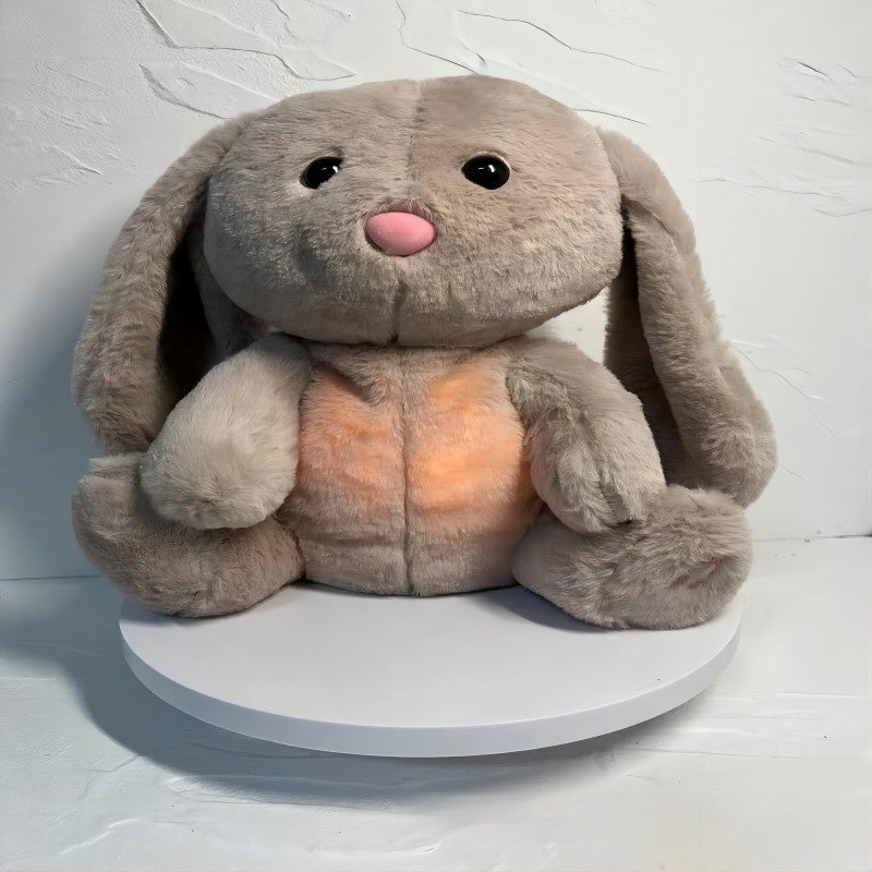 Breathing plush rabbit held on a bed